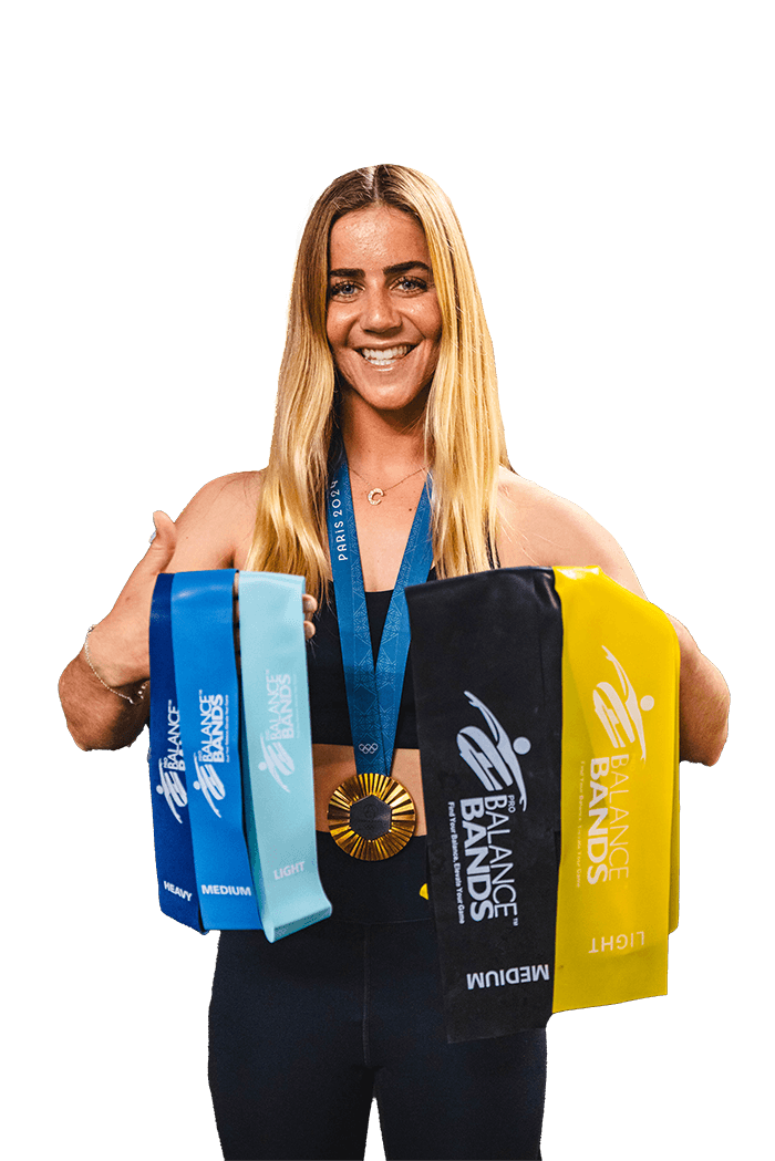 Gold Medalist Olympian Caroline Marks holding up the full set of Pro Balance Bands while wearing her 2024 Olympic Gold Medal of surfing around her neck.